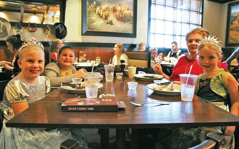 Eden Washington, 8, Baylee Crouch, 8, Sandee Logan and Genevieve Washington, 5, enjoy some breakfast.