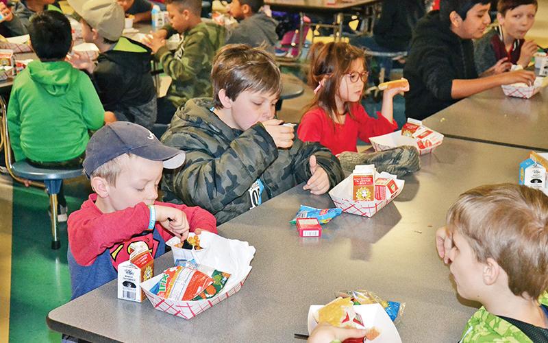 Level Grove Elementary students (from left) Lyle Tatum, Jackson Payne, Jaime Erwin; and Aaron Martin (across table) enjoy breakfast Thursday morning before school.