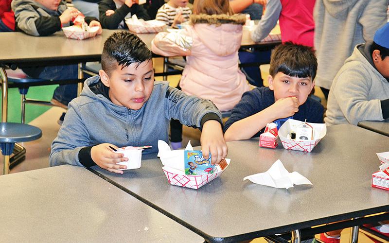 Level Grove Elementary students Christopher Negrete and Jonah Edmonds enjoy their breakfast Thursday morning before starting the school day. All students in Habersham County receive free breakfast before school in the morning.