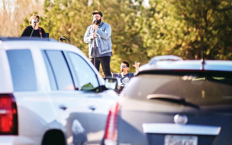 Eric and Misty Wilcox sing at The Torch’s drive-up prayer service Saturday to promote social distancing during this COVID-19 crisis. Photo courtesy of The Torch