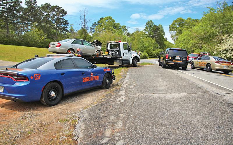 A two-car crash Sunday put four people in the hospital after an alleged failure to yield at a stop sign.