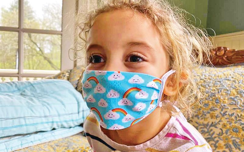 Ruby Benton poses with one of the homemade masks.