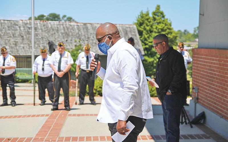 Dr. Ernest Burns leads a prayer at the  Cornelia Train Depot on Thursday along with members of the Grant-Reeves Veterans of Foreign Wars Post 7720 as part of the National Day of Prayer. Photo by ERIC PEREIRA/Staff