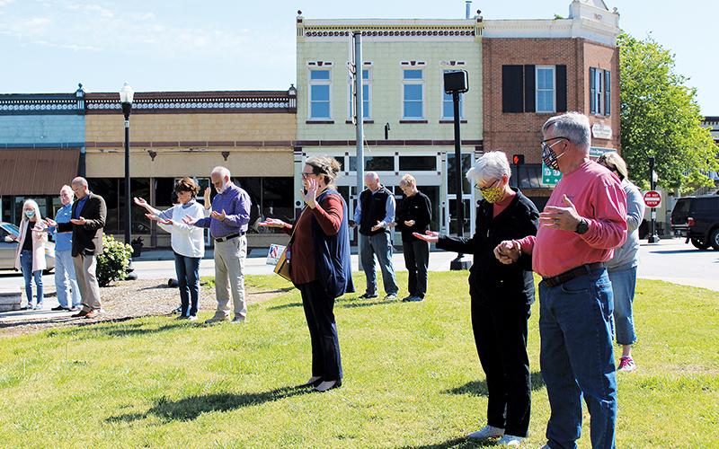 Residents pray in the Clarkesville downtown square during their city’s portion of the National Day of Prayer festivities. Photo by ISAIAH SMITH/Staff