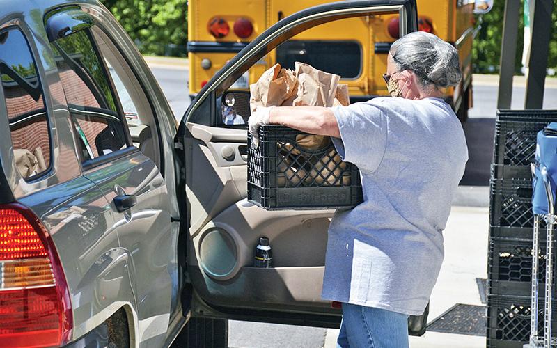 Jackie Cane of Woodville Elementary delivers a crate of meals to a family May 1.