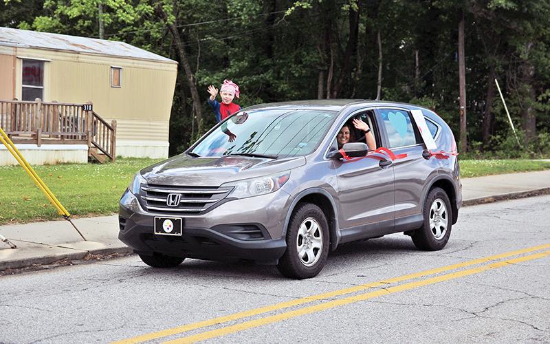 Cornelia Elementary School teachers along with Habersham County public safety personnel drove through the streets of Cornelia to wish them a happy and safe summer on Thursday.  Principal Amy McCurdy said more than 50 vehicles were estimated to have participated. Photos by ERIC PEREIRA/Staff