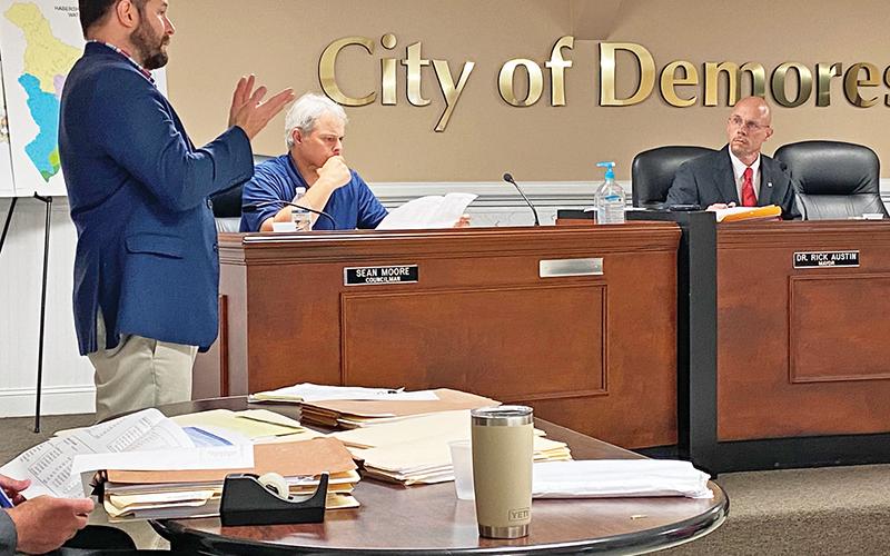 Cornelia Mayor John Borrow (left) makes a presentation Tuesday to the Demorest City Council, including Councilman Sean Moore (seated middle) and Mayor Rick Austin. Photo by ERIC PEREIRA