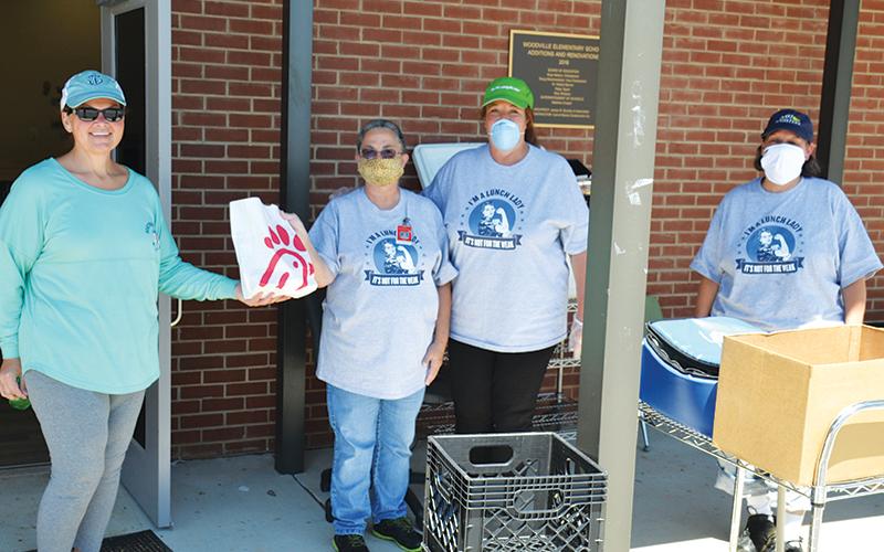 Stephanie Walker, transportation director for Habersham County Schools, delivers Chick-fil-A lunches to Woodville Elementary’s nutrition crew Friday including Jackie Cane, manager Liz Martin and Mary Beth Justice of the Ninth Grade Academy.