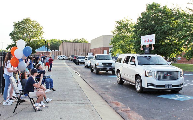 Habersham Central two-sport athlete Hadden Carswell waves to a parade of community members who came out to Habersham County’s Ninth Grade Academy to show their support for him. Carswell came home Friday from the rehabilitation center in which he was being treated for injuries stemming from a February car crash.