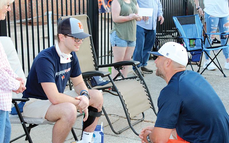 Hadden Carswell (left) talks with Habersham Central baseball coach Chris Akridge on Friday night at a community event celebrating his release from the hospital.