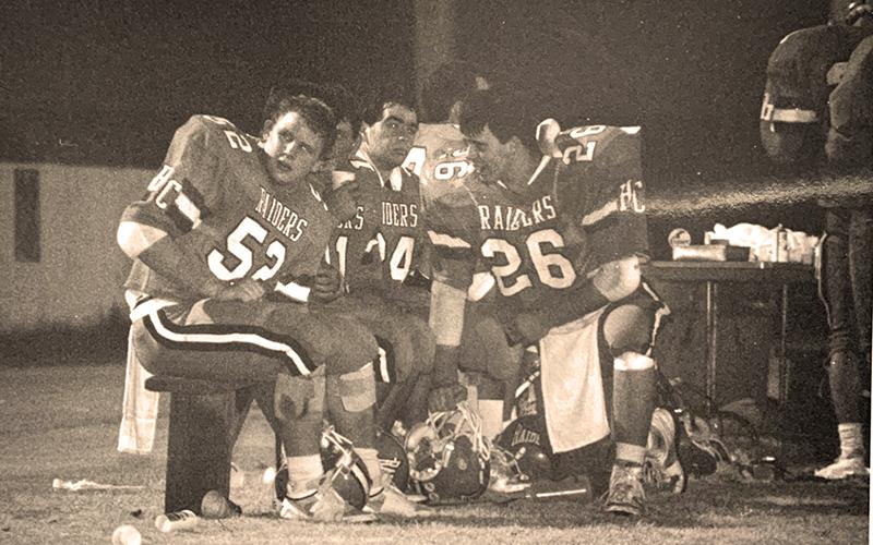 had Radcliffe (26) consults with teammates A.J. Eash and Eric Hooper during a time out from a Habersham Central game in 1987.