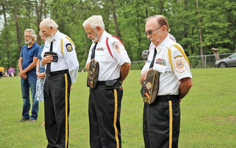 Veterans of Foreign Wars members Barry Church, Garnett Hulsey and Bill McAllister bow their heads during the benediction.