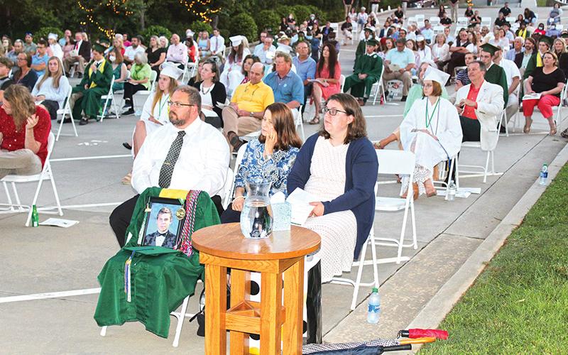 The family of Stephen Bowman – from left, father Matthew, mother Cherie and sister Sarah Black – listen to remarks at Friday’s graduation at Tallulah Falls School. Stephen graduated from the school this year, but passed away in a drowning accident June 13.