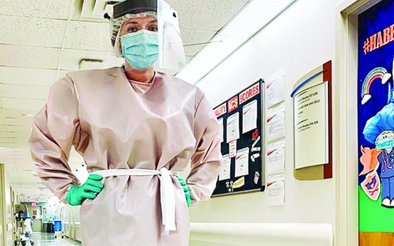 A staffer shows off one of the new gowns Habersham Medical Center purchased from Ford Motor Company.