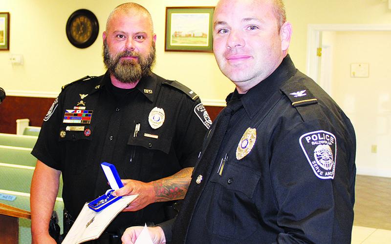 Baldwin Interim Chief Matthew Nall (right) recognized Lt. Ryan Provost at Monday’s Baldwin City Council meeting.