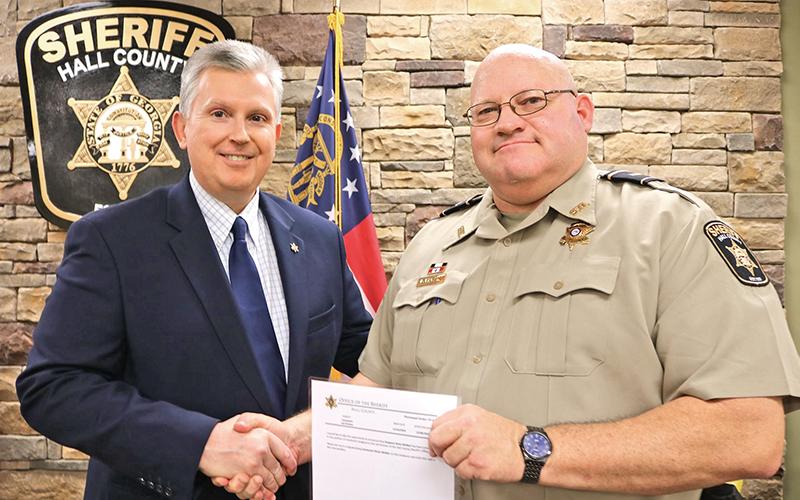 Lt. Brian McNair of the Hall County Sheriff’s Office gets his promotion from Sheriff Gerald Couch in the fall of 2019. McNair, a Clarkesville resident, died Monday from complications related to COVID-19.