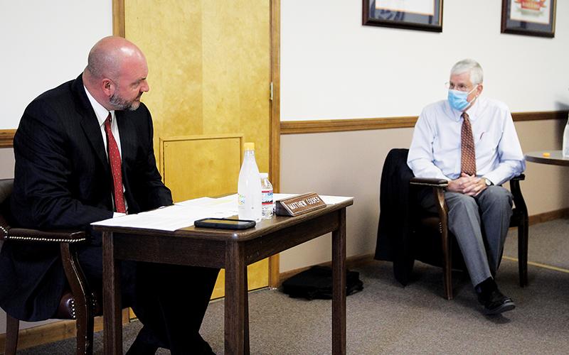 Superintendent Matthew Cooper and Board of Education member John Elger debate the issue of school reopening at Monday’s Board of Education meeting.