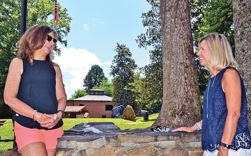 Recently retired Demorest Elementary teachers Allison Roland (left) and Mary McDuffie chat at Demorest Springs Park on Monday. The two put in 30 years each teaching Habersham County students, 19 of those together at Demorest.