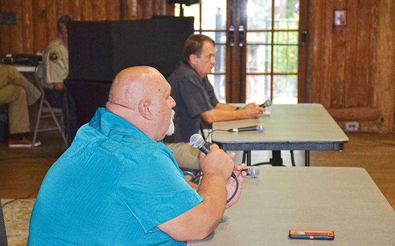 District 1 candidates Bruce Palmer (foreground) and Jeffery Lunsford talked about the issues Wednesday night.