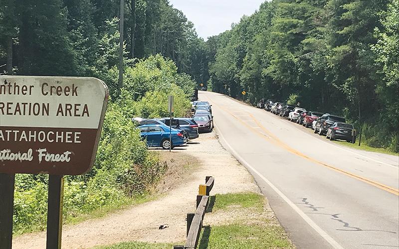 Crowds were heavy at Panther Creek on Fourth of July weekend, including some cars that were towed for being illegally parked.