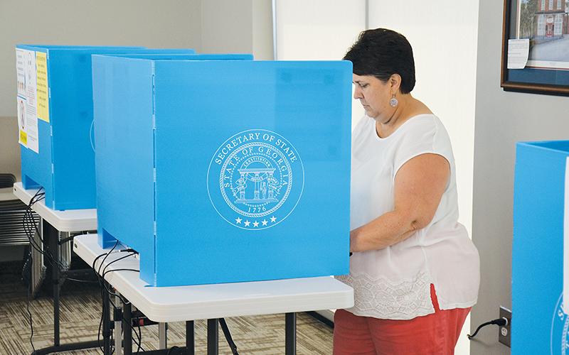 Beth Palmer of Clarkesville casts her vote Thursday at the Habersham County administration building. Early voting ended Friday and the runoff election is Tuesday, Aug. 11.
