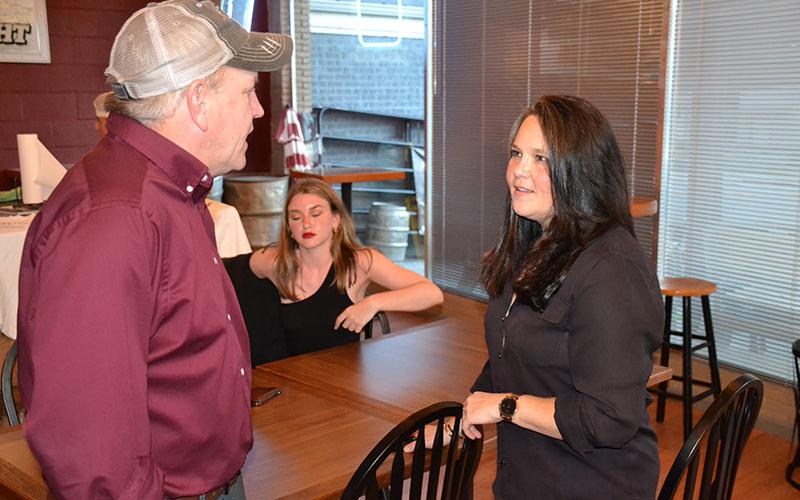 Habersham County Commissioner Natalie Crawford (right) converses with Commissioner Tim Stamey at her campaign event Tuesday night in Cornelia.