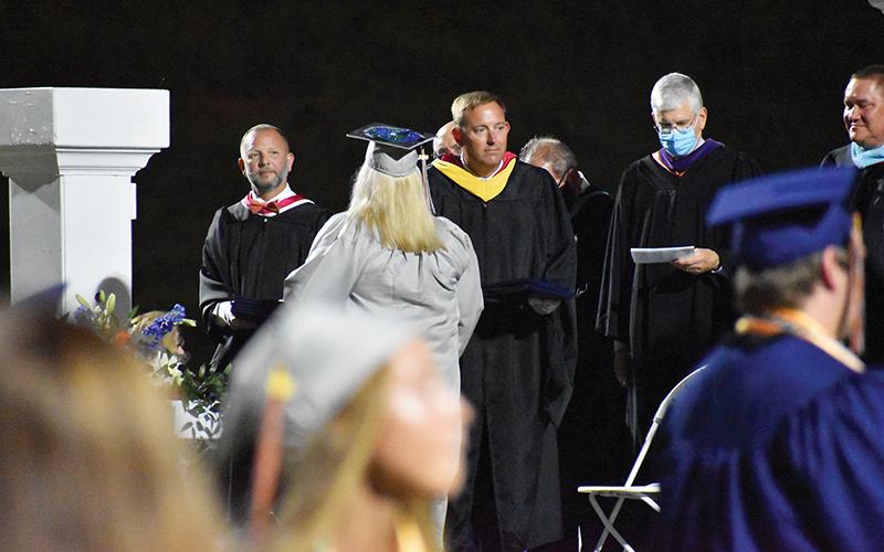 HCHS Principal Jonathan Stribling hands out diplomas on Friday night.