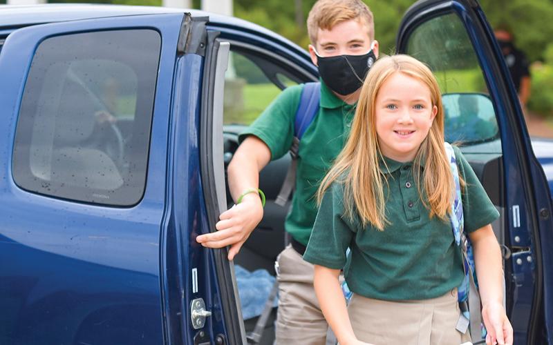 Toccoa-based siblings Charles Harris, a seventh grader and Catherine Harris, a fifth-grader, arrive at the middle school campus of Tallulah Falls School on the first day Monday. Photo by E. Lane Gresham