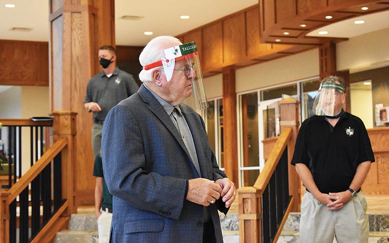 Dr. Larry Peevy, Head of School for Tallulah Falls, demostrates use of a face shield that will be issued to every student. Face coverings will be used in the halls but the shields allow students and teachers to see each others’ faces during instruction.
