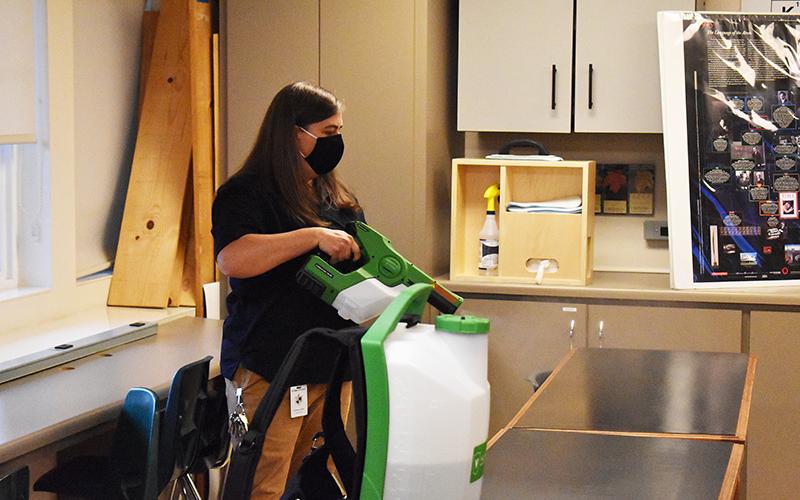 Liana Wellborn demonstrates the spraying of the bioesque solution that will help sanitize classrooms at Tallulah Falls School.