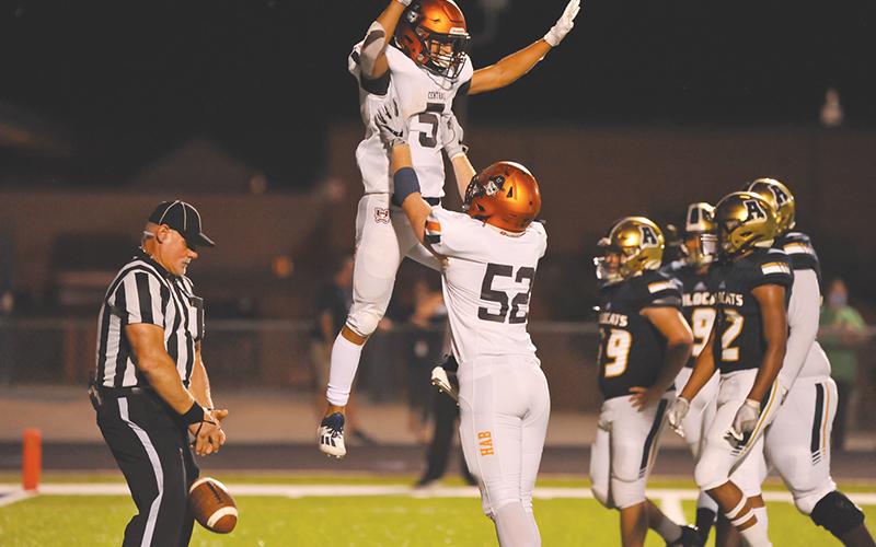 Habersham Central’s Jackson Clouatre gets a lift from Pierce Vickery after scoring one of his three touchdowns against Apalachee on Friday night. Photos by TOM ASKEW