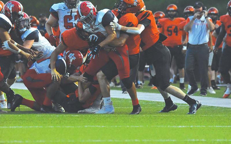Habersham Central’s defense stacks up a Madison ballcarrier during Friday’s game. The first-team defense shut the Red Raiders out in the 27-6 win. LILLIAN VAN TASSELL/Special