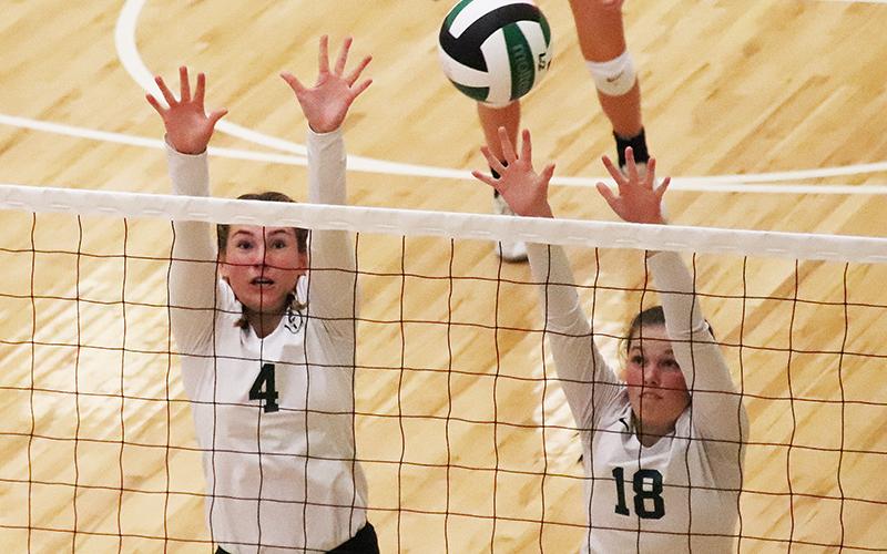 Tallulah Falls’ Abby Carlan (4) and Sarah Jennings elevate for the block during a recent match. BRIAN CARTER/Special