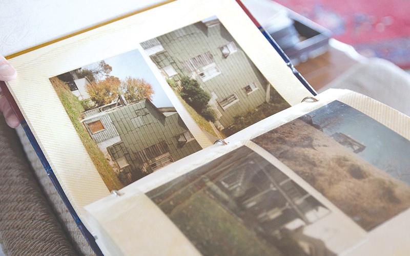 Walter Looney shows some photos of what his house used to look like when he first bought it in the late 1980s.
