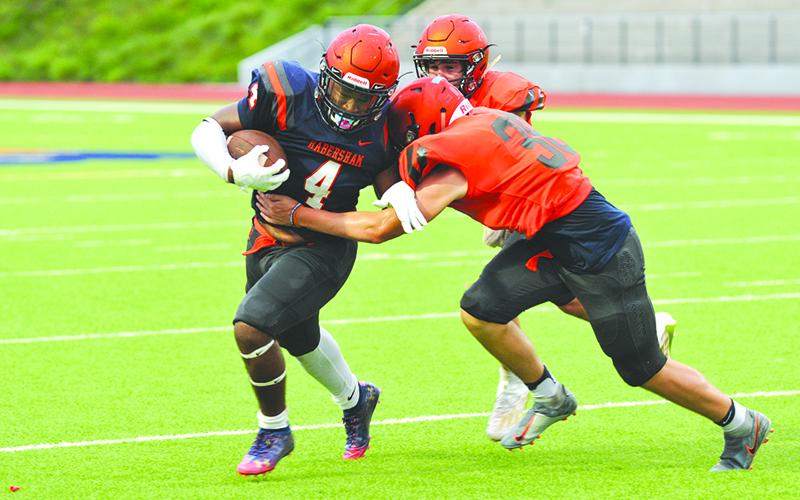 Simarcus Burney gains a few yards after contact during the Raiders' intrasquad scrimmage Aug. 27. Photos by TOM ASKEW/Special