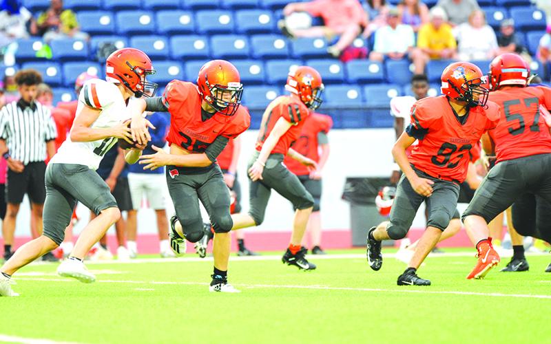 Carson Parker fakes to Braydon Henslee during the intrasquad scrimmage.