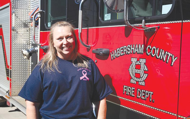 Angela Turk is a firefighter/paramedic at Habersham Emergency Services station 9. She is wearing her breast cancer awareness shirt for her fundraiser to provide mammograms to women and men who can’t afford them.