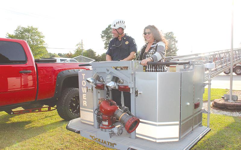 Councilwoman Stephanie Almagno and Fire Chief Joe Roy prepare to take in Baldwin’s aerial view from the basket of one of the new trucks before Monday’s meeting.