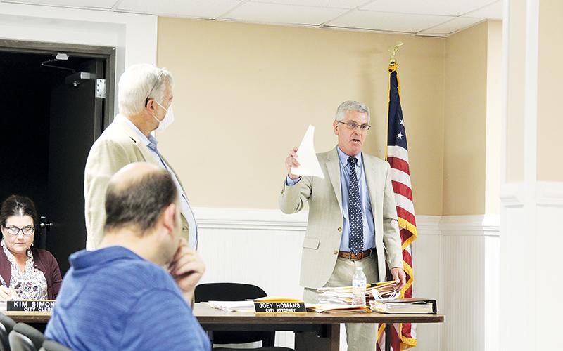 City attorney Joey Homans speaks at the Demorest City council meeting Tuesday night regarding the security agreement with Habersham County Medical Center. Voices were raised as Dr. Hendrix’s attorney Abe Sharony interjected during the meeting. ERIC PEREIRA/Staff