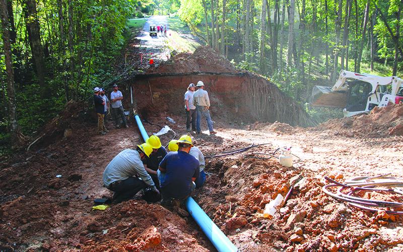 Habersham EMC and Demorest Water Department crews work together to restore power and water on Laurel Oak Drive. Photo by ERIC PEREIRA