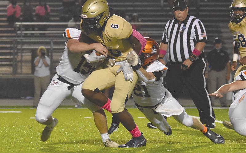 Habersham Central's Patrick Tedder and Austin Wood look to bring down a Dacula runner on Friday night. LILLIAN VANTASSEL/Special