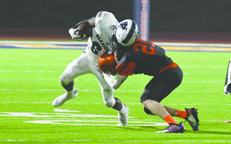Habersham Central’s Austin Wood lays a stick on White County’s Silas Mulligan during last Friday’s game at John Larry Black Field. TOM ASKEW/Special