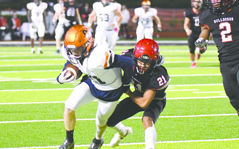 Habersham Central’s Austin Wood looks to break free of Winder-Barrow’s Alex Cha during Friday night’s game. TOM ASKEW/Special