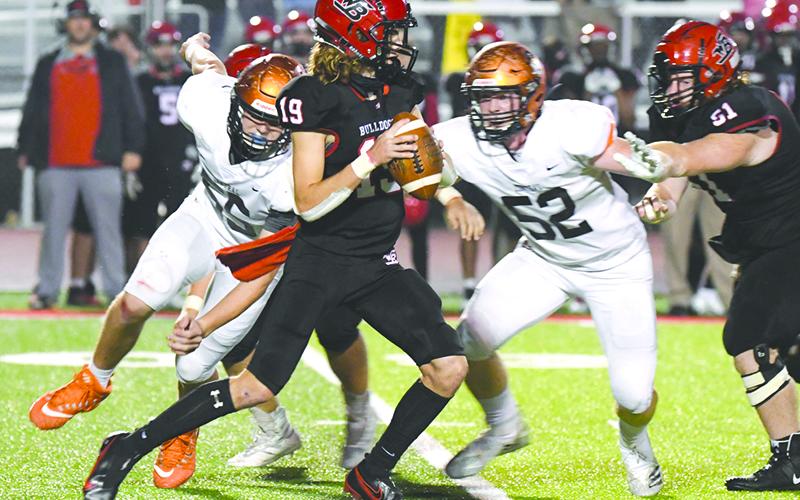 Habersham Central’s Pierce Vickery (52) and Jonathan Adams (55) pressure Winder-Barrow quarterback Trevor Summerfield during Friday night’s win over the Bulldoggs. TOM ASKEW/Special