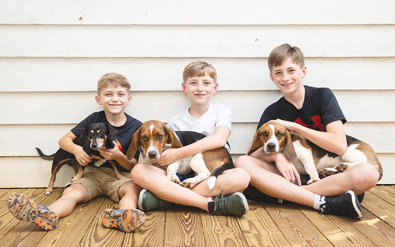 Jase, Reilly and T.J. Cox each hold one of the family’s beloved pets. Seargent (left) returned home soon after escaping, but Rosie was lost for nearly five days, while Amelia was found after being missing for six days.