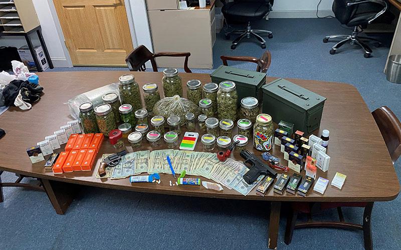 Guns, drugs and money were seized from a Clarkesville storage shed on Friday.