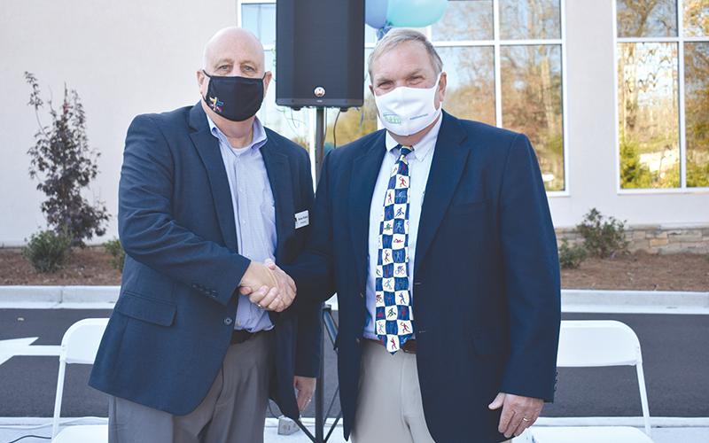 Dr. F. Stuart Sanders (right) is congratulated by Habersham County Chamber of Commerce Chairman Sidney Roland III after a legacy wall was erected in his honor Tuesday at the new Rehabilitation &amp; Orthopedics Complex at Habersham Medical Center. CHAMIAN CRUZ/Staff