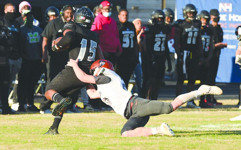 Habersham Central’s Garrett Heaton lunges to take down Shiloh quarterback Antonio Meeks during Saturday’s game. TOM ASKEW/Staff