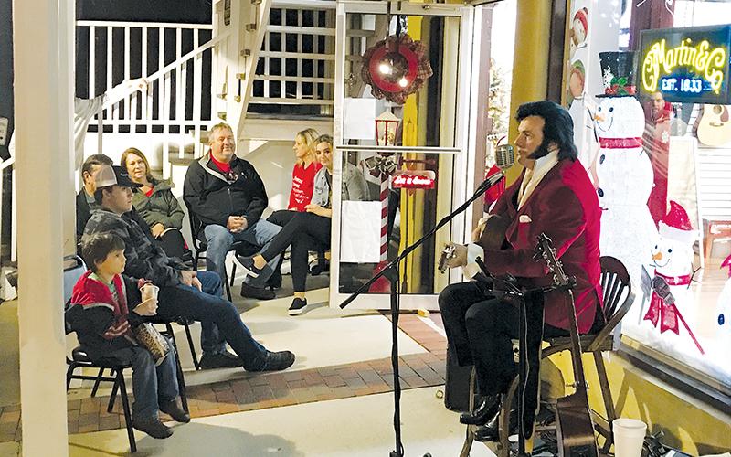 Elvis Presley (Mark Eskew) performs for holiday goers at Acoustic Cellar Guitars on Saturday night in Clarkesville.