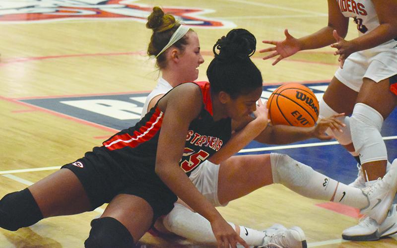 Habersham Central’s Taylor Wade battles Stephens County’s Ranjah Verdell for a loose ball during Friday night’s game.